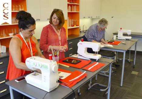Attendees at IDEA:TE create hand-sewn laptop cases in the textile arts workshop.